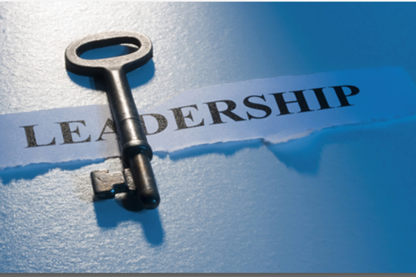 Key atop a piece of paper displaying the text 'Leadership'