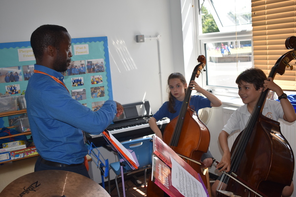 Teacher and two young double bass students