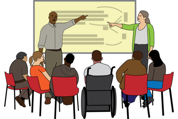 A white woman and a black man point to a presentation board in front of a group of people.