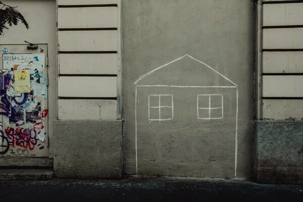 Chalk drawing of a home on a concrete wall