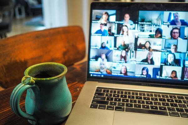 image shows video chat over laptop, and a mug of tea