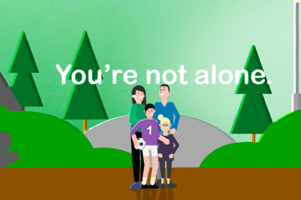 An image of a boy with his parents outside in a park. Text is overlaid saying "you are not alone"