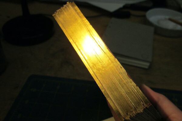 Photo of light reflected off a gilt edge on an unbound textblock