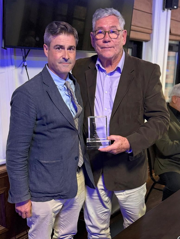 Andre Odendaal being presented with The Howard Milton Award for 2026 by Geoff Levett