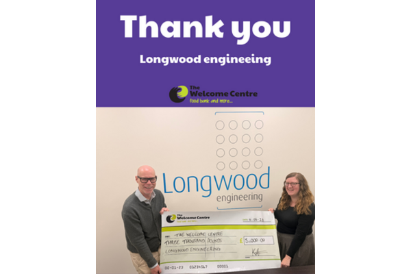 Lockwood engineering staff holding £3000 cheque