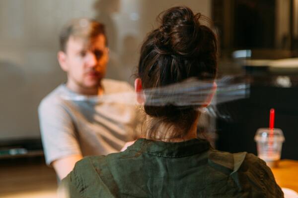 photo-of-people-sitting-near-wooden-table