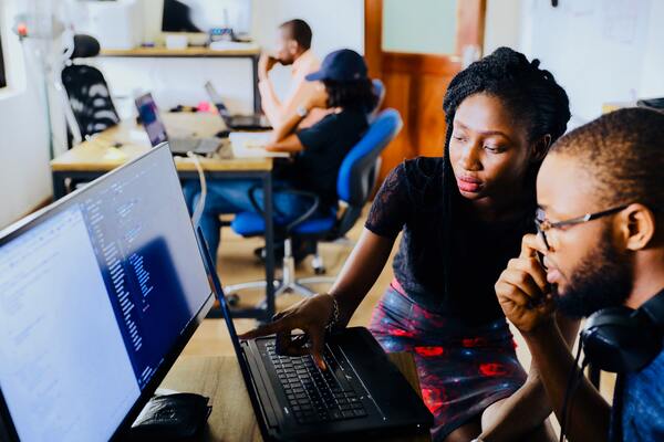 People looking at a computer screen. 