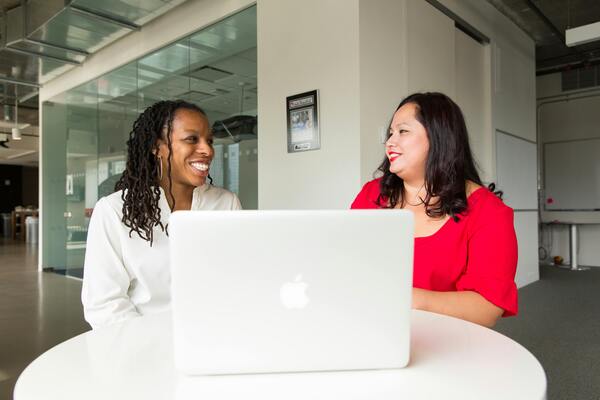 https://www.pexels.com/photo/woman-wearing-red-top-holding-silver-macbook-1181722/