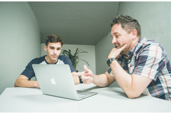 Two men at a laptop