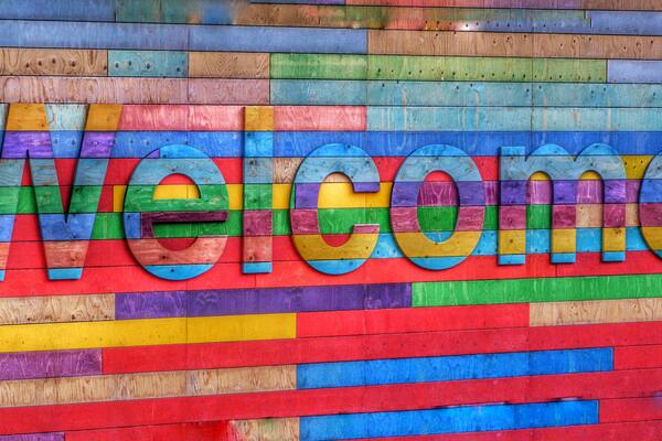 Sign saying Welcome in rainbow letters