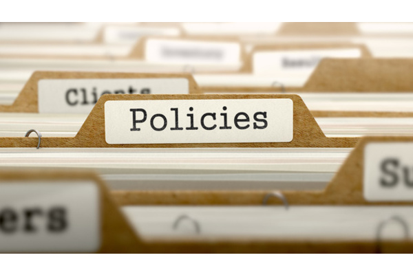 Paper files, with a tab saying policies